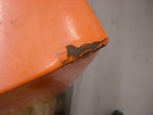 Battered, rusty corner of Dig Box