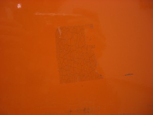 Plastic tape on a newsbox that has developed a network of fractures