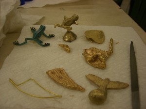 A frog, leaf, blob, bird and tooth shape cast in various methods.